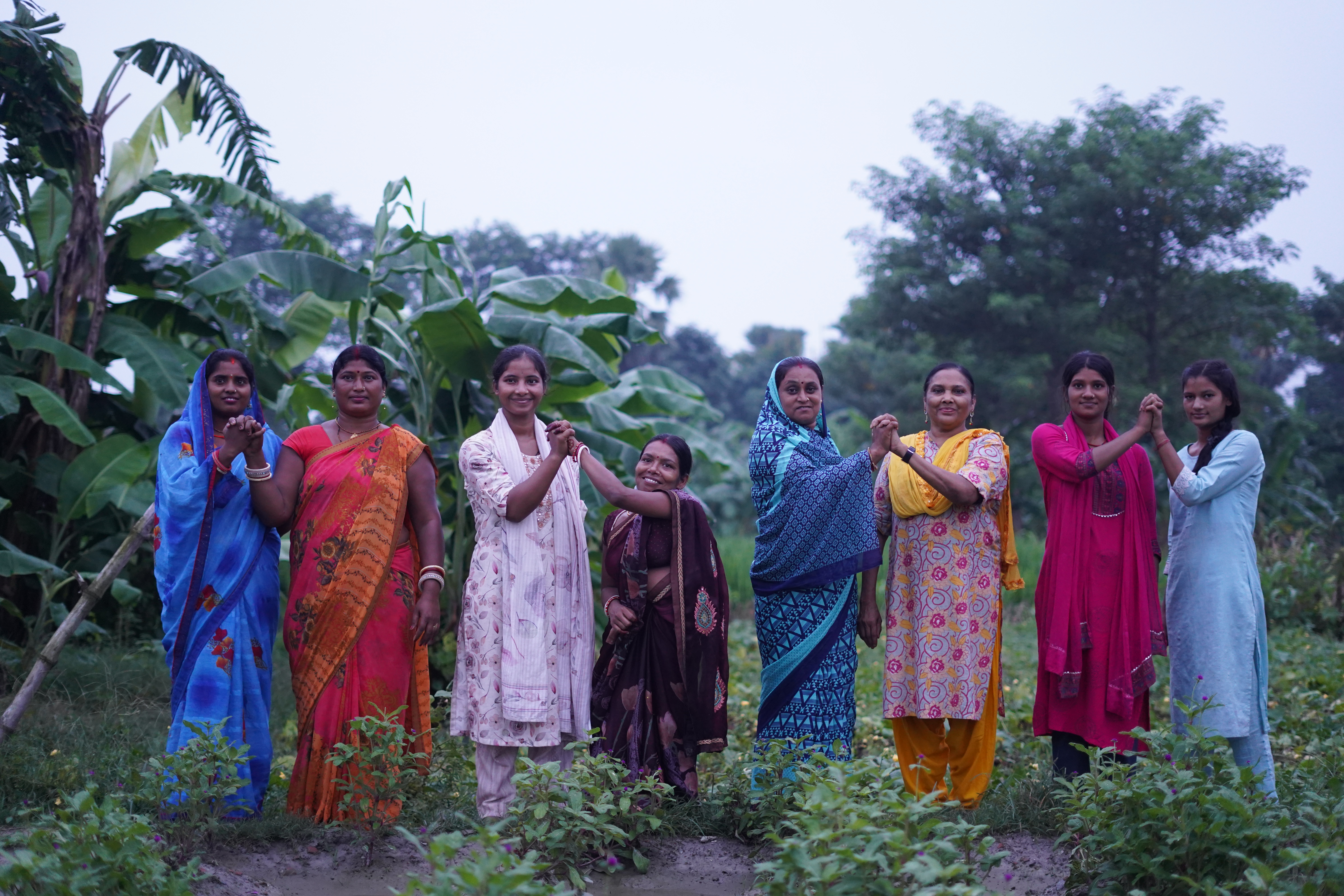 Roshni Leader Bharti (in the center wearing a brown sari) on field with community members